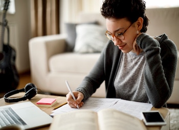 person writing at a desk