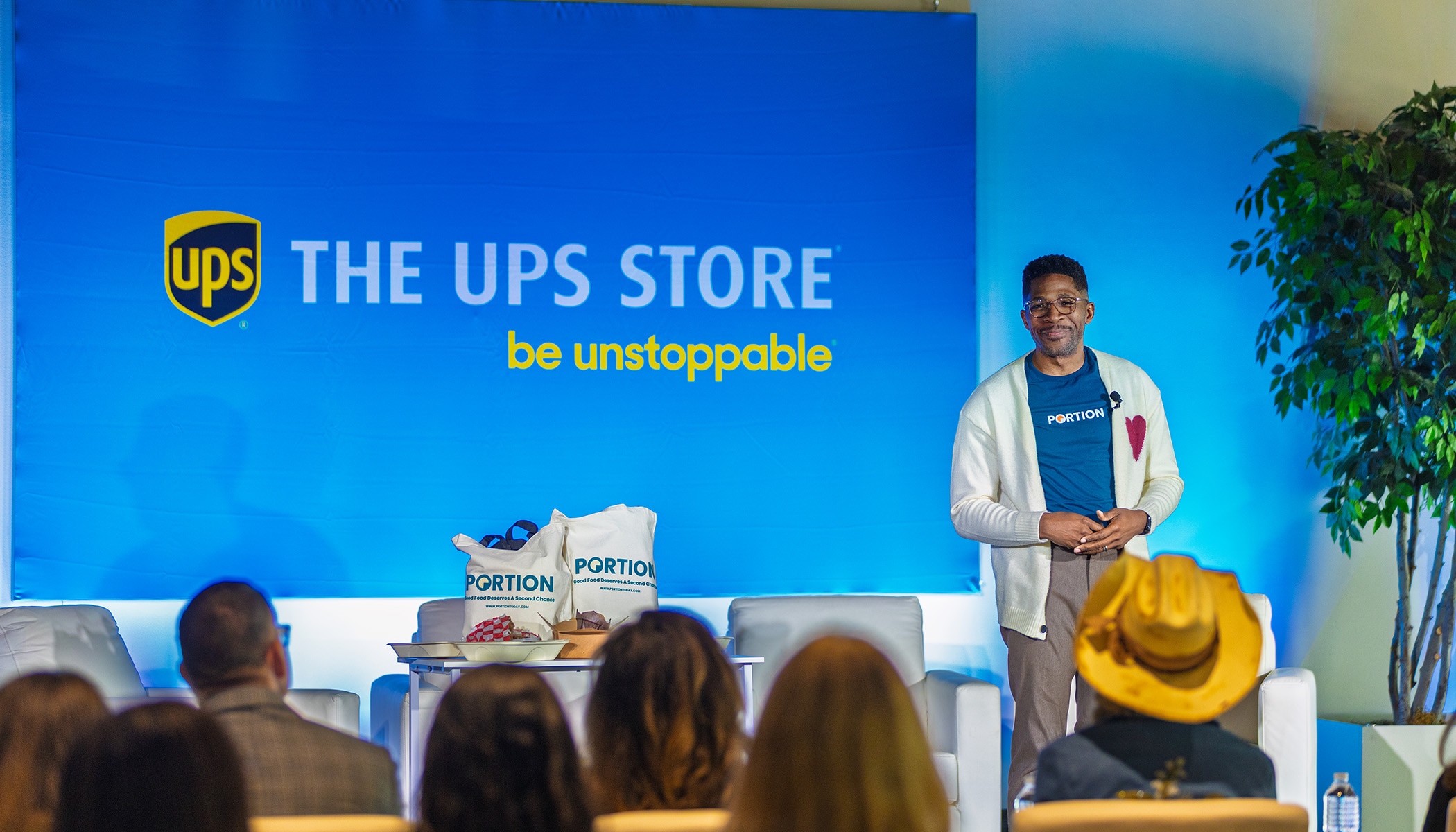 man standing on stage presenting