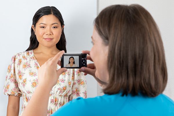 Associate handing passport and photos to customer
