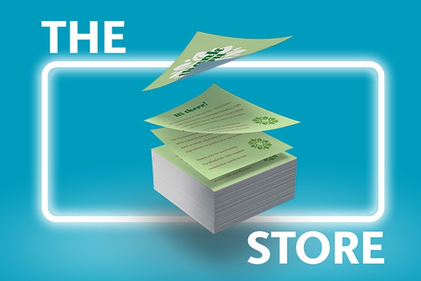 Stack of printed green flyers on a green background in front of a glowing white square